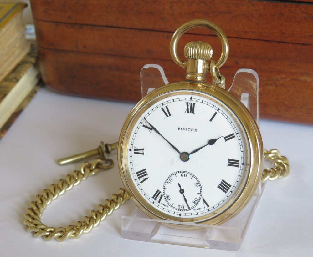 A gold-toned open-face pocket watch with a white dial, black Roman numerals, subsidiary seconds sub-dial, and an attached curb chain.