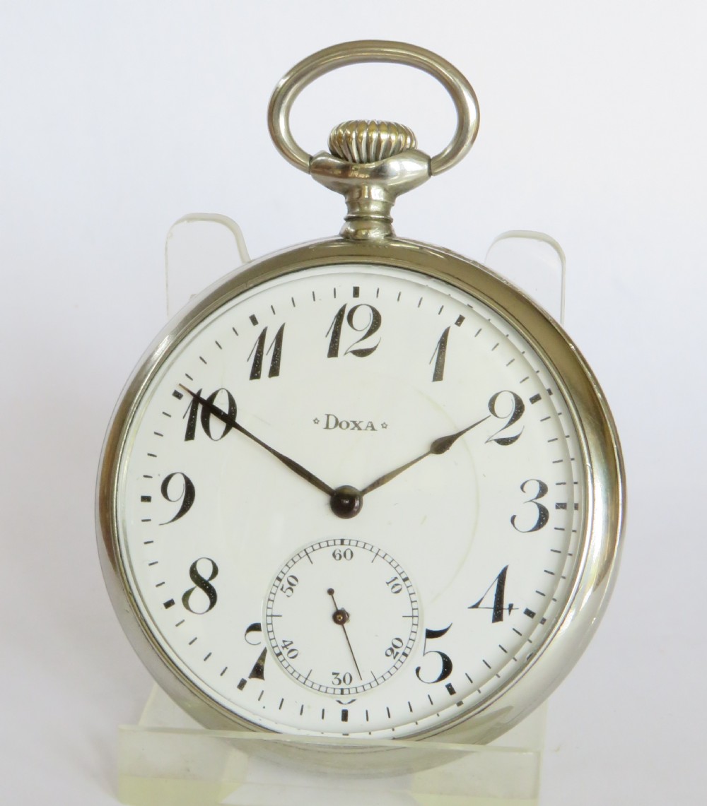 An open-face antique pocket watch featuring a white enamel dial with black Arabic numerals, a sub-seconds dial, and a polished silver-toned casing. View II
