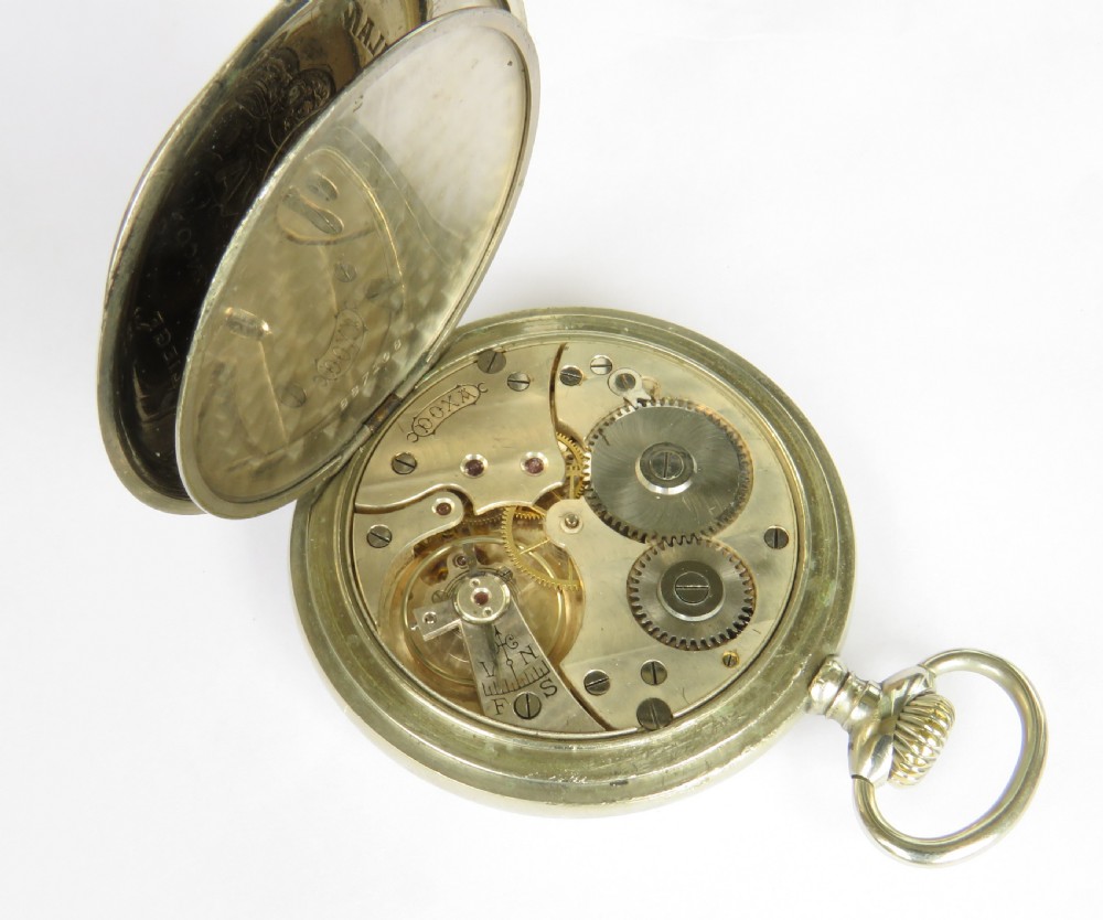 An open-face antique pocket watch featuring a white enamel dial with black Arabic numerals, a sub-seconds dial, and a polished silver-toned casing. View V