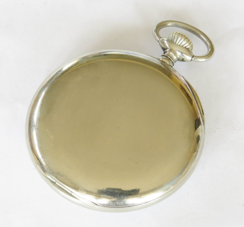 An open-face antique pocket watch featuring a white enamel dial with black Arabic numerals, a sub-seconds dial, and a polished silver-toned casing. View VI