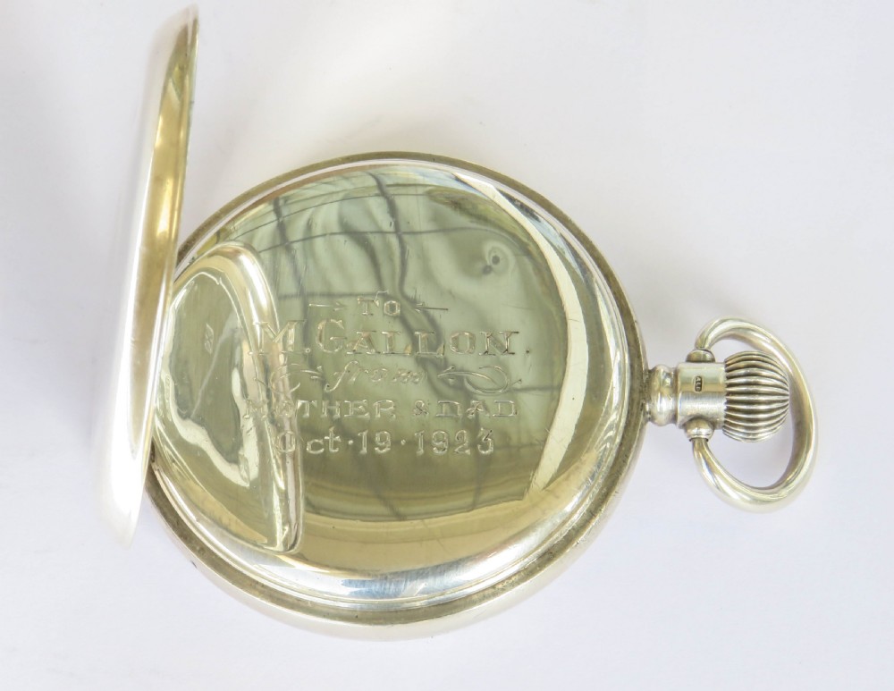 An open silver half hunter pocket watch featuring a white enamel dial with black Arabic numerals, a sub-seconds dial, and a polished silver casing. View IV