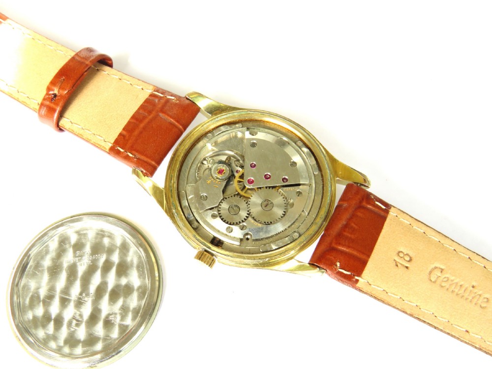 A 1950s gents Baume Bimatic wrist watch with a gold-plated round case, champagne dial, and textured brown leather strap. View IV