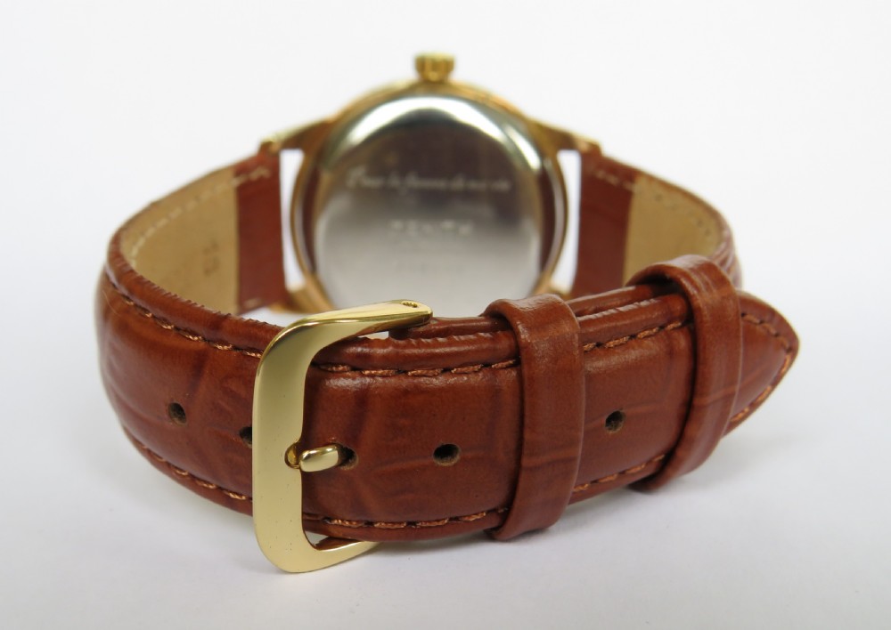 A vintage 1960s Zenith Stellina mechanical wristwatch featuring a gold-plated case, champagne sub-seconds dial, and a brown crocodile-grain leather strap. View V