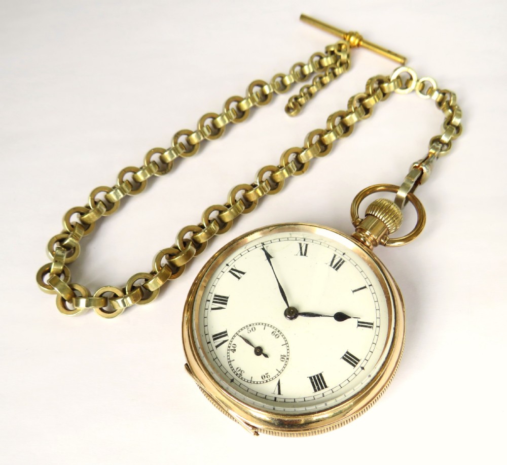 A 1930s gold-tone open-face pocket watch with a white dial, Roman numerals, a sub-seconds dial, and a linked Albert chain with a T-bar. View II