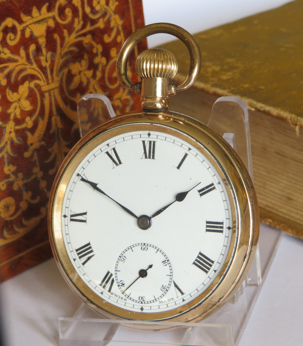 A gold-plated open-face pocket watch featuring a white enamel dial with black Roman numerals and a small seconds sub-dial at six oclock.