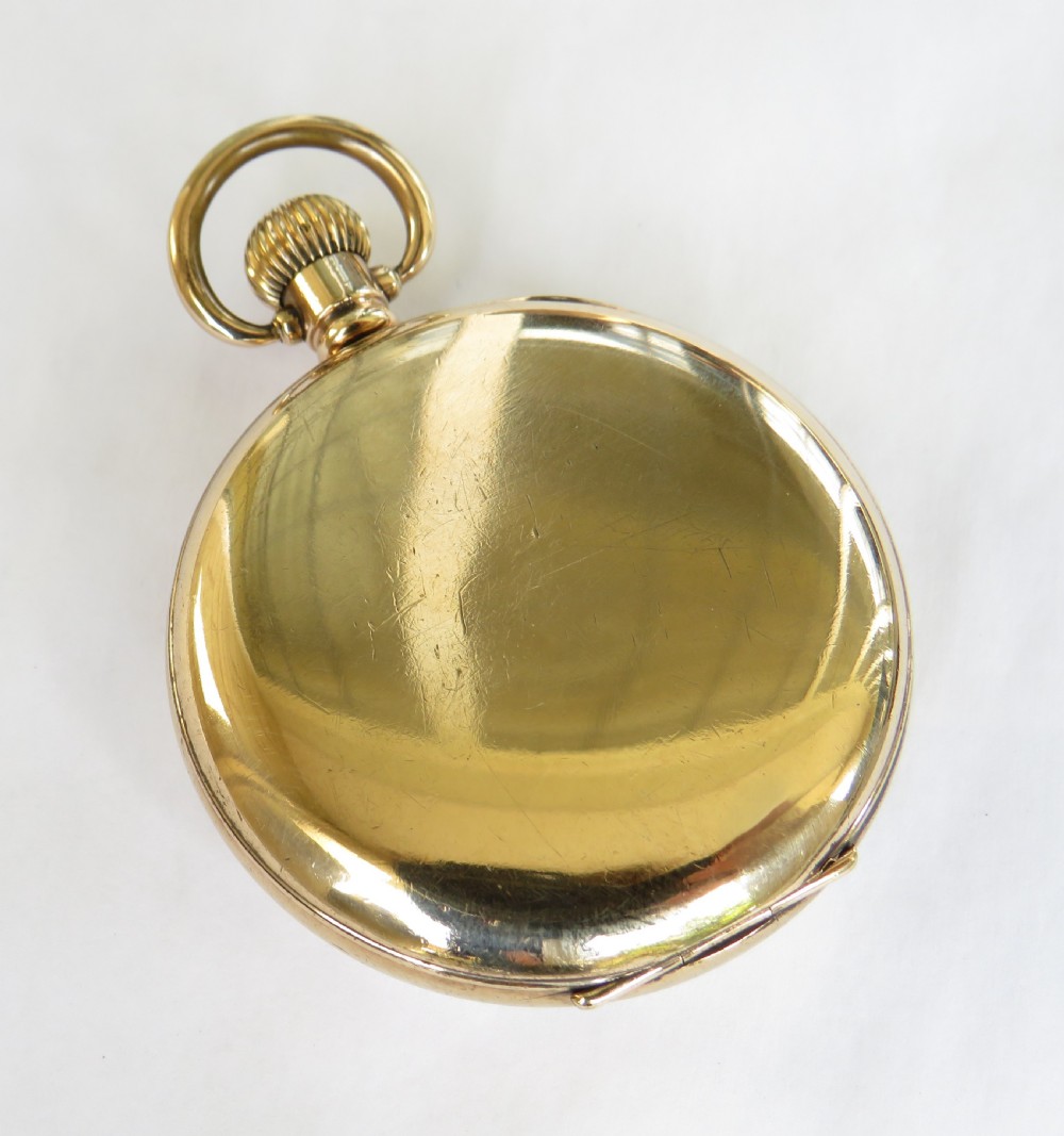 A gold-plated open-face pocket watch featuring a white enamel dial with black Roman numerals and a small seconds sub-dial at six oclock. View V