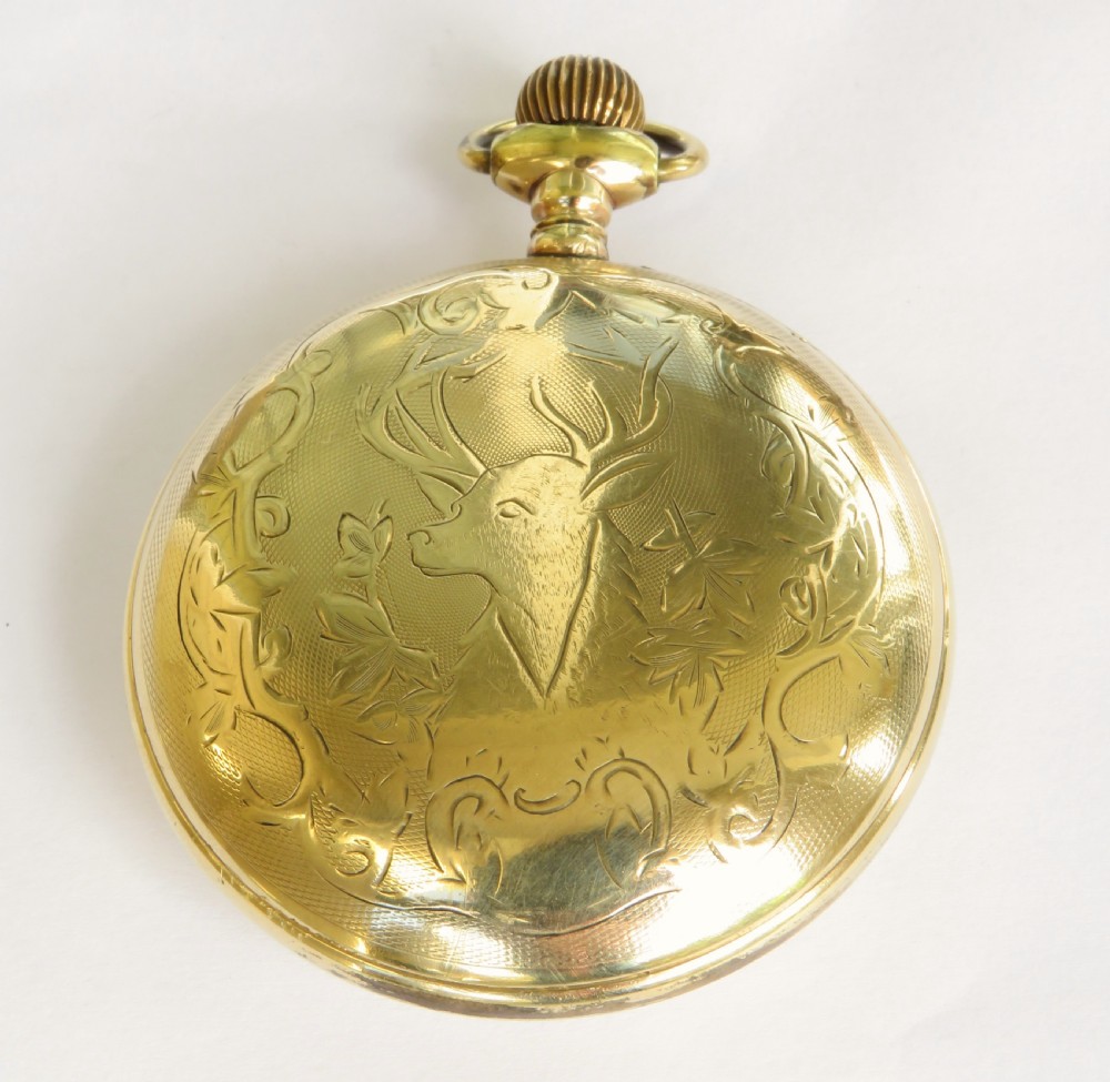 An open-face antique gold-tone pocket watch featuring a white enamel dial, black Arabic hour numerals, red 24-hour markings, and a subsidiary seconds sub-dial. View IV