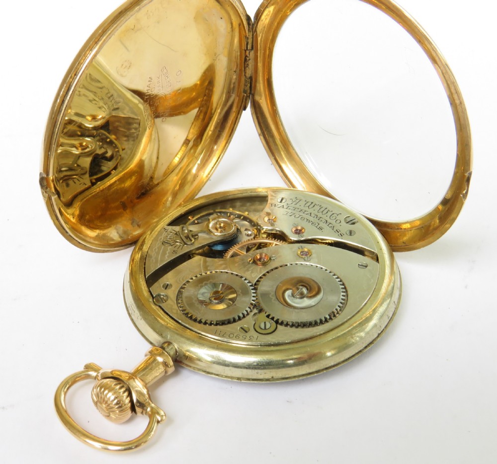 An Edwardian open-face pocket watch featuring a gold-toned casing, dark Arabic numerals, an engine-turned dial centre, and a lower sub-seconds dial. View II