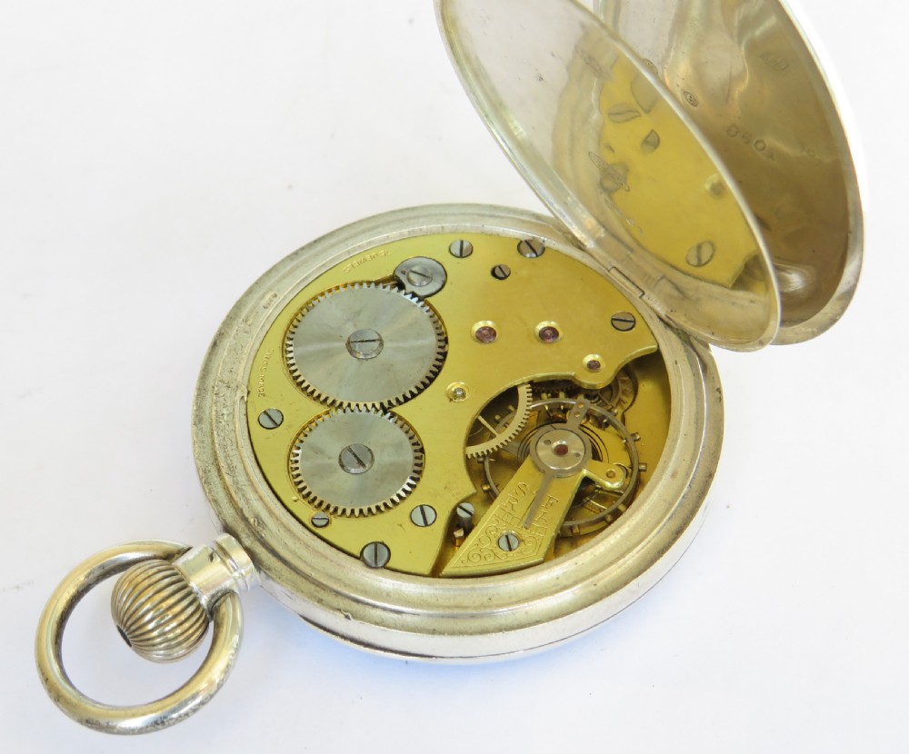 An antique open-face silver pocket watch featuring a white enamel dial with black Roman numerals and a subsidiary seconds dial at the base. View IV