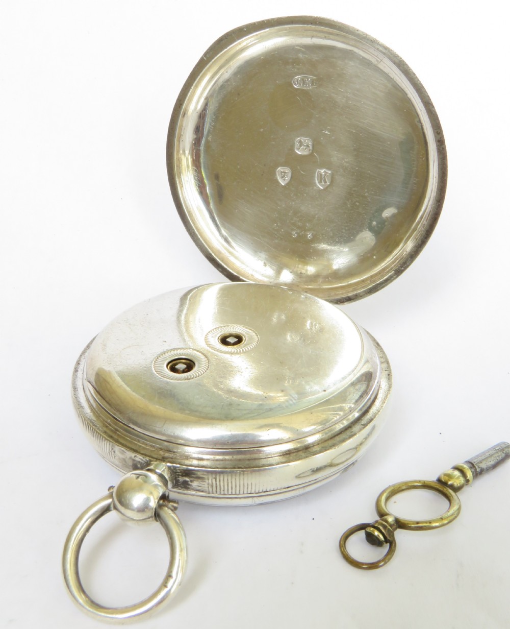 An open-face silver pocket watch with a white enamel dial, black Roman numerals, blued steel hands, and a separate winding key. View III