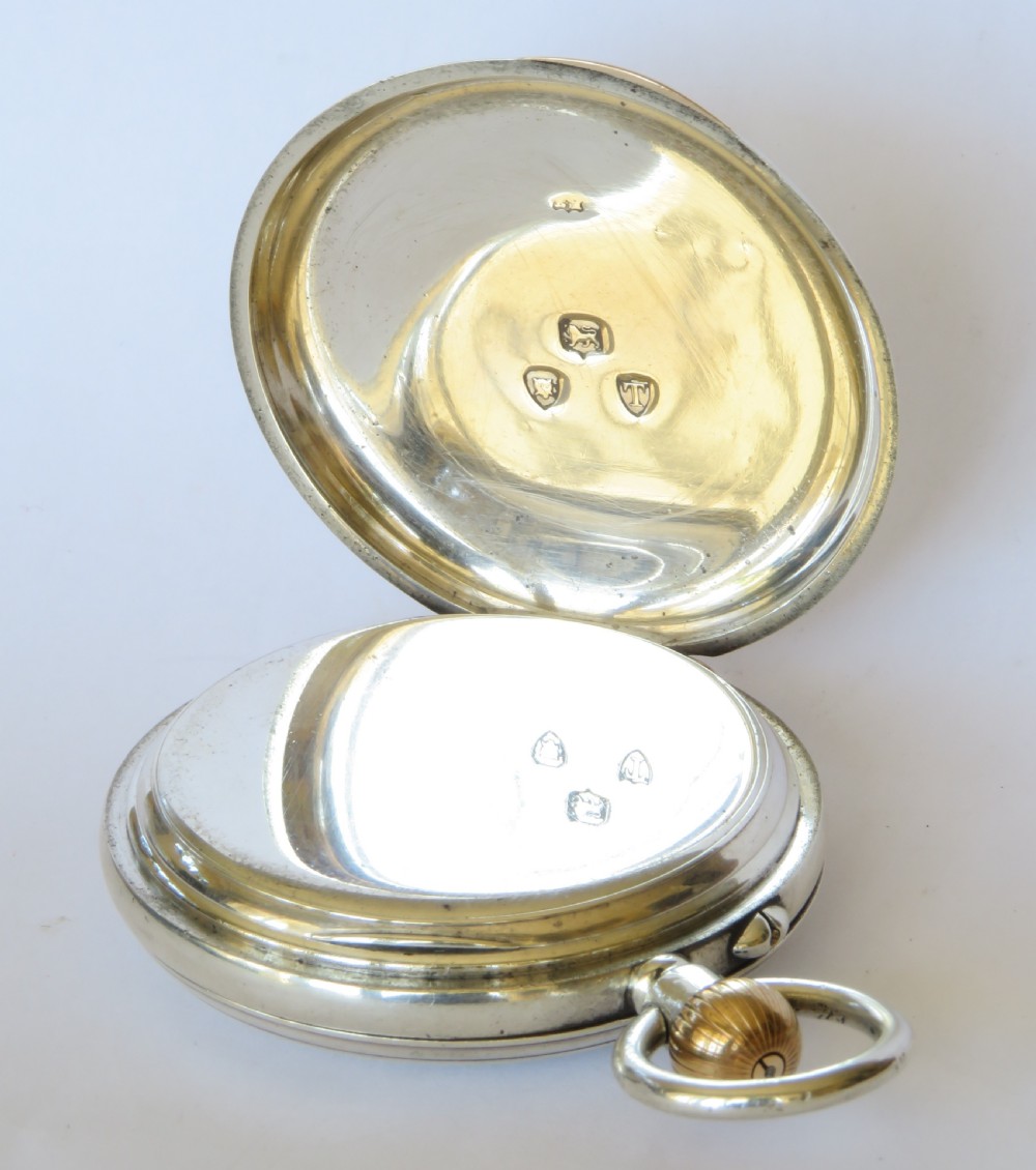 A late Victorian sterling silver half hunter pocket watch featuring dark blue enamel Roman numerals on the outer cover and a central glass window. View III