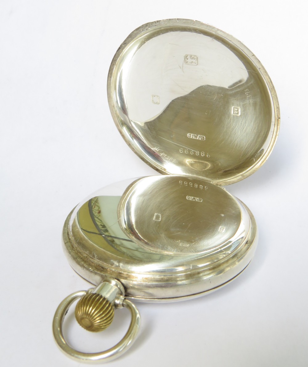 An antique silver half-hunter pocket watch featuring an outer enamel chapter ring with Roman numerals around a central circular glass window. View III