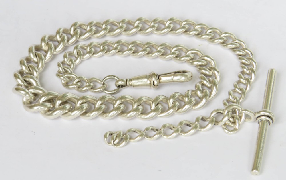 A sterling silver Albert pocket watch chain composed of polished curb links, a central T-bar attachment, and a swivel clip.