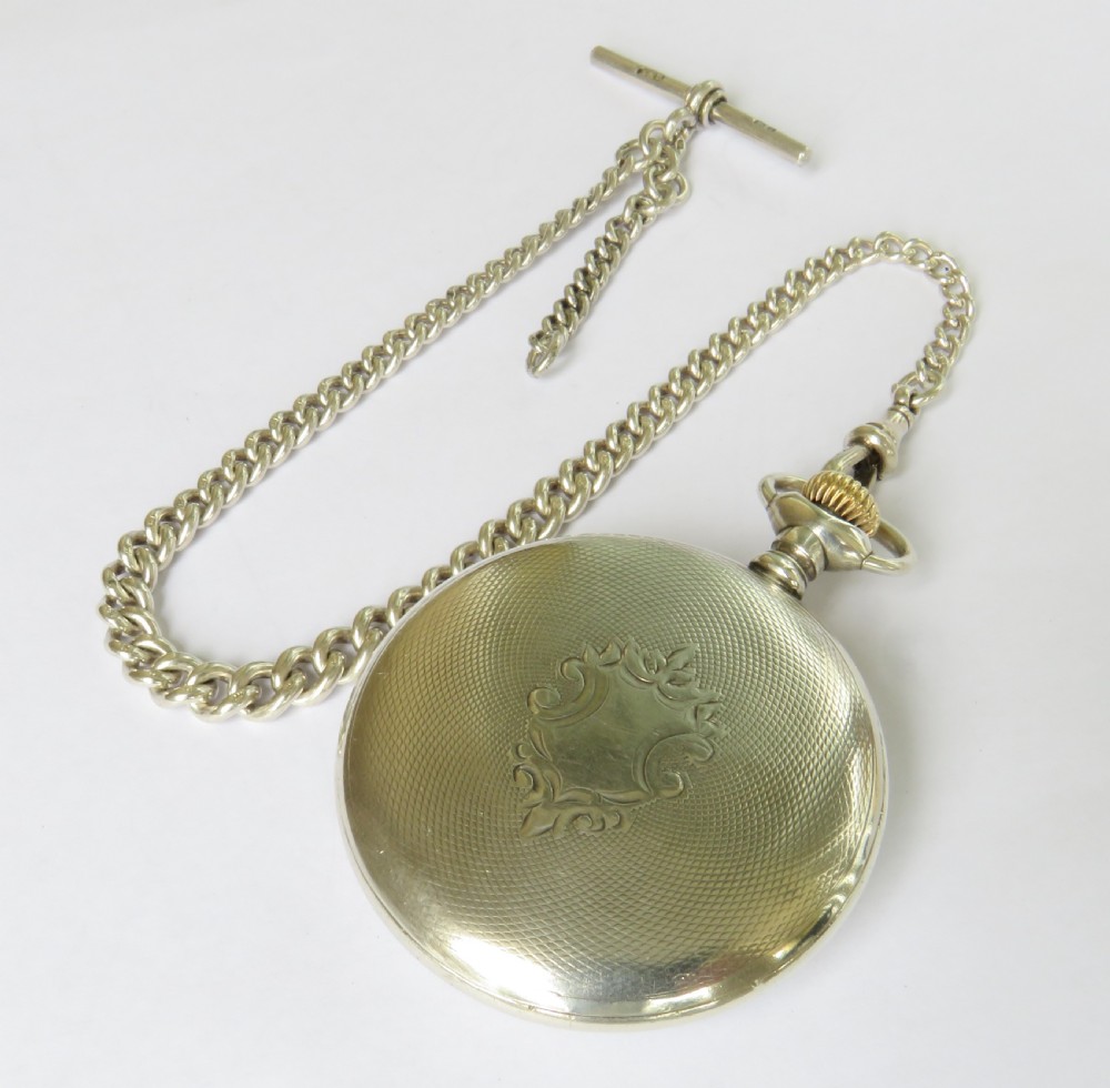 An antique silver open-face Elgin pocket watch with a white enamel dial, Roman numerals, a subsidiary seconds dial, and an attached silver curb chain with a T-bar. View III