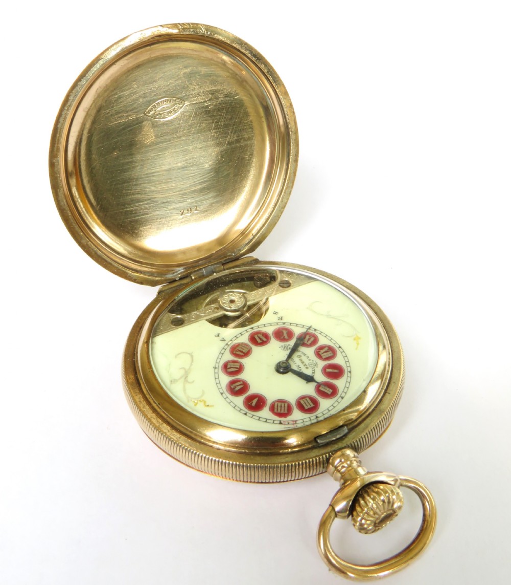 An open full hunter pocket watch featuring a gold case, a cream enamel dial with red Roman numeral cartouches, and an exposed balance bridge. View II