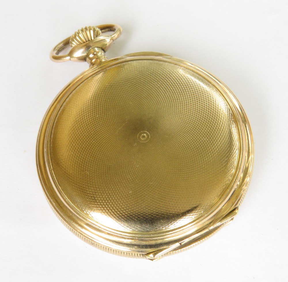 An open full hunter pocket watch featuring a gold case, a cream enamel dial with red Roman numeral cartouches, and an exposed balance bridge. View VI