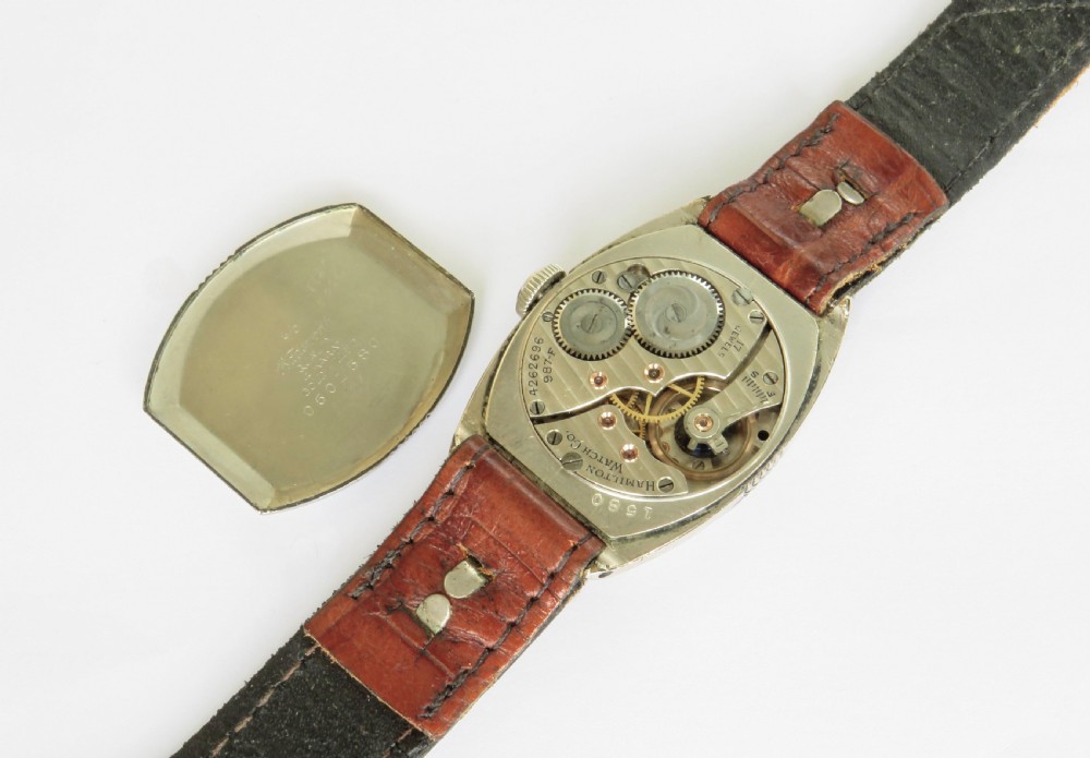 A 1930s Art Deco gents Hamilton wristwatch with a gold-toned tonneau case, cream dial, Arabic numerals, sub-seconds dial, and brown leather strap. View III