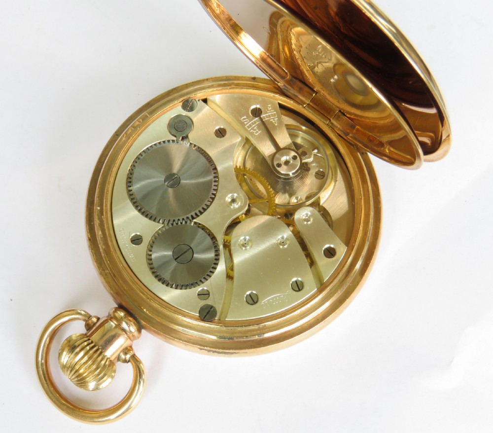 An open gold full hunter pocket watch displaying a white enamel dial with black Roman numerals and a subsidiary seconds dial. View III