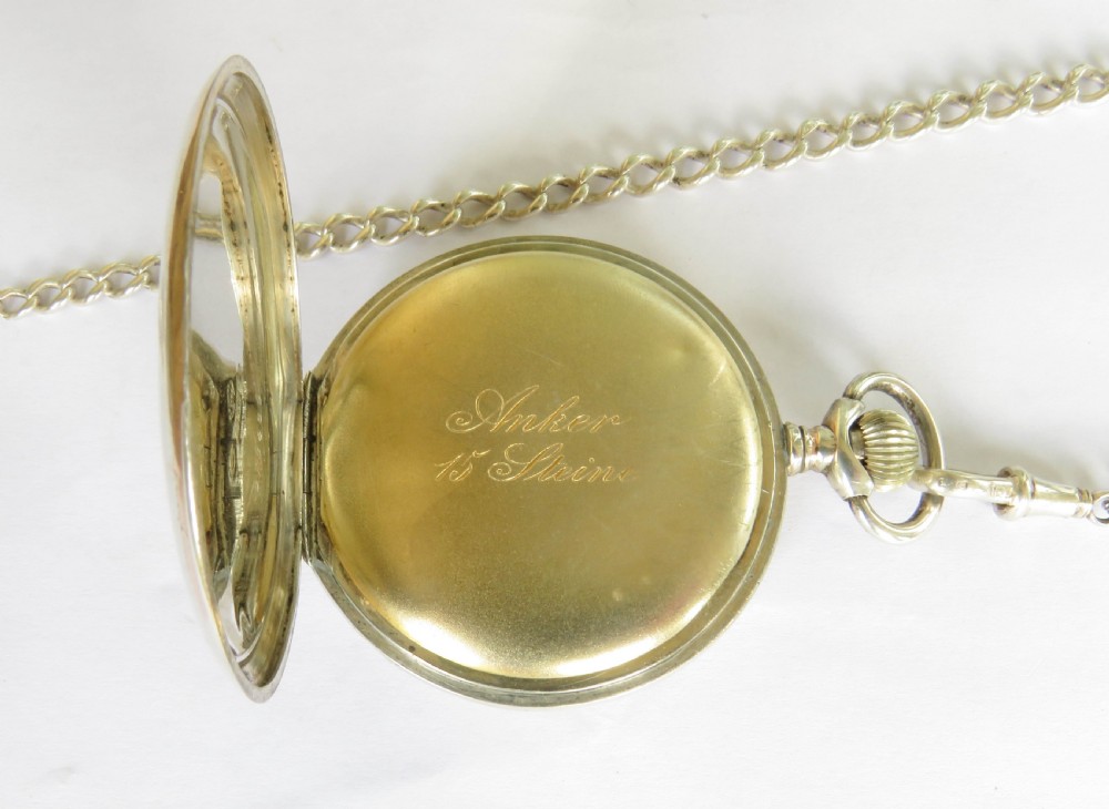 An Edwardian open-face silver pocket watch with a white enamel dial, Arabic numerals, a sub-seconds dial, and an attached silver T-bar chain. View III