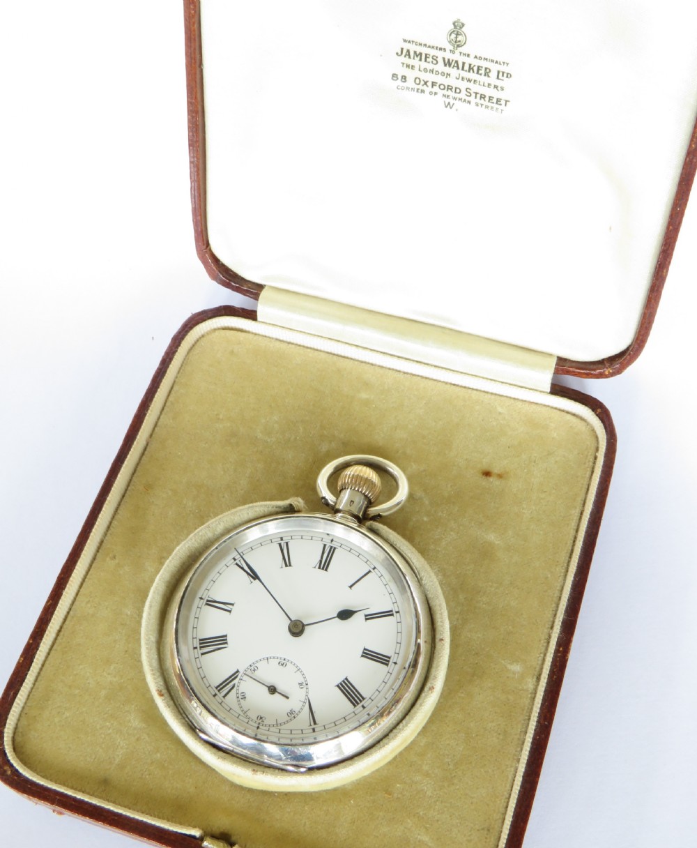An antique silver open-face pocket watch featuring a white enamel dial with black Roman numerals and a sub-seconds dial. View II