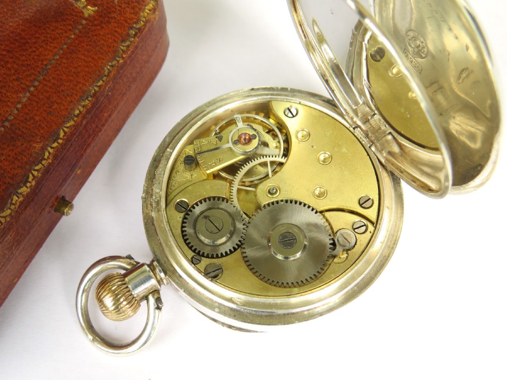 An antique silver open-face pocket watch featuring a white enamel dial with black Roman numerals and a sub-seconds dial. View IV