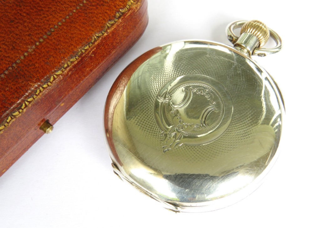 An antique silver open-face pocket watch featuring a white enamel dial with black Roman numerals and a sub-seconds dial. View V