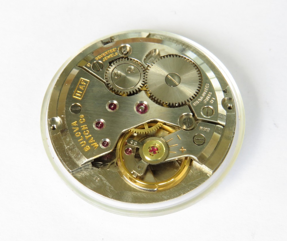 A 1961 gents Bulova wrist watch with a silver-tone case, cream dial with gold Arabic numerals, sub-seconds dial, and a brown leather strap. View III