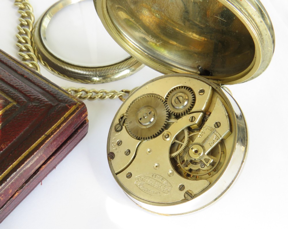 A 1930s mechanical pocket watch featuring a white enamel dial with Roman numerals, a small seconds dial, and an attached curb link chain. View III
