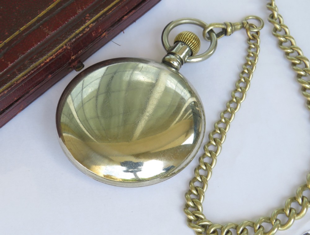 A 1930s mechanical pocket watch featuring a white enamel dial with Roman numerals, a small seconds dial, and an attached curb link chain. View IV