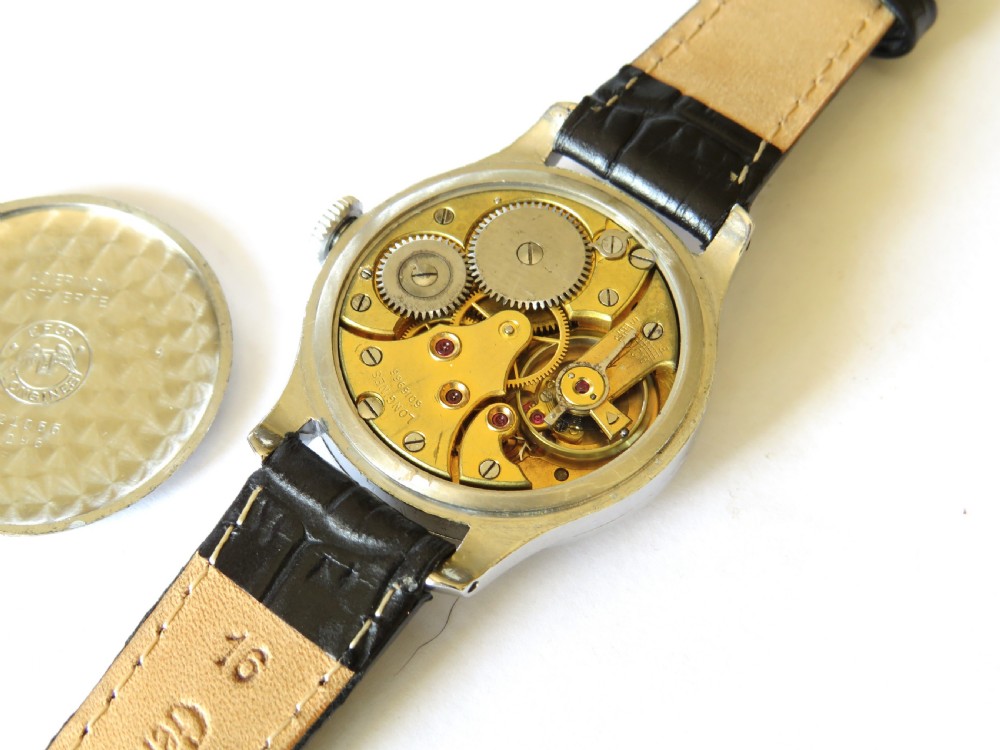 A vintage 1940s gents Longines wristwatch featuring a round silver-tone case, cream dial with sub-seconds register, and a black leather strap. View III