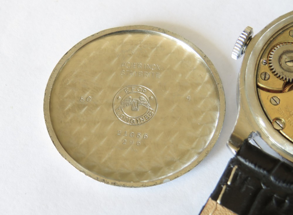 A vintage 1940s gents Longines wristwatch featuring a round silver-tone case, cream dial with sub-seconds register, and a black leather strap. View IV