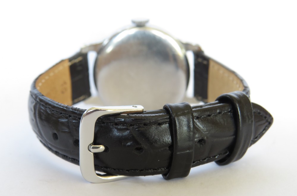 A vintage 1940s gents Longines wristwatch featuring a round silver-tone case, cream dial with sub-seconds register, and a black leather strap. View V