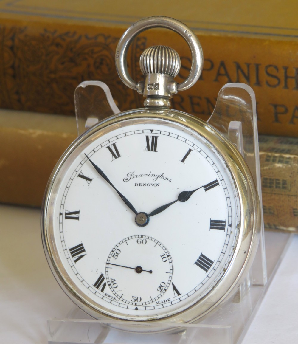 A 1940s silver open-face pocket watch with a white dial, Roman numerals, blued steel hands, and a subsidiary seconds subdial at six oclock.