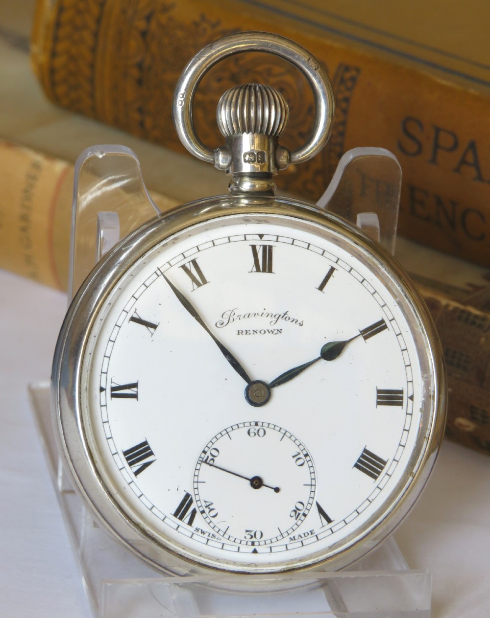 A 1940s silver open-face pocket watch with a white dial, Roman numerals, blued steel hands, and a subsidiary seconds subdial at six oclock. View II