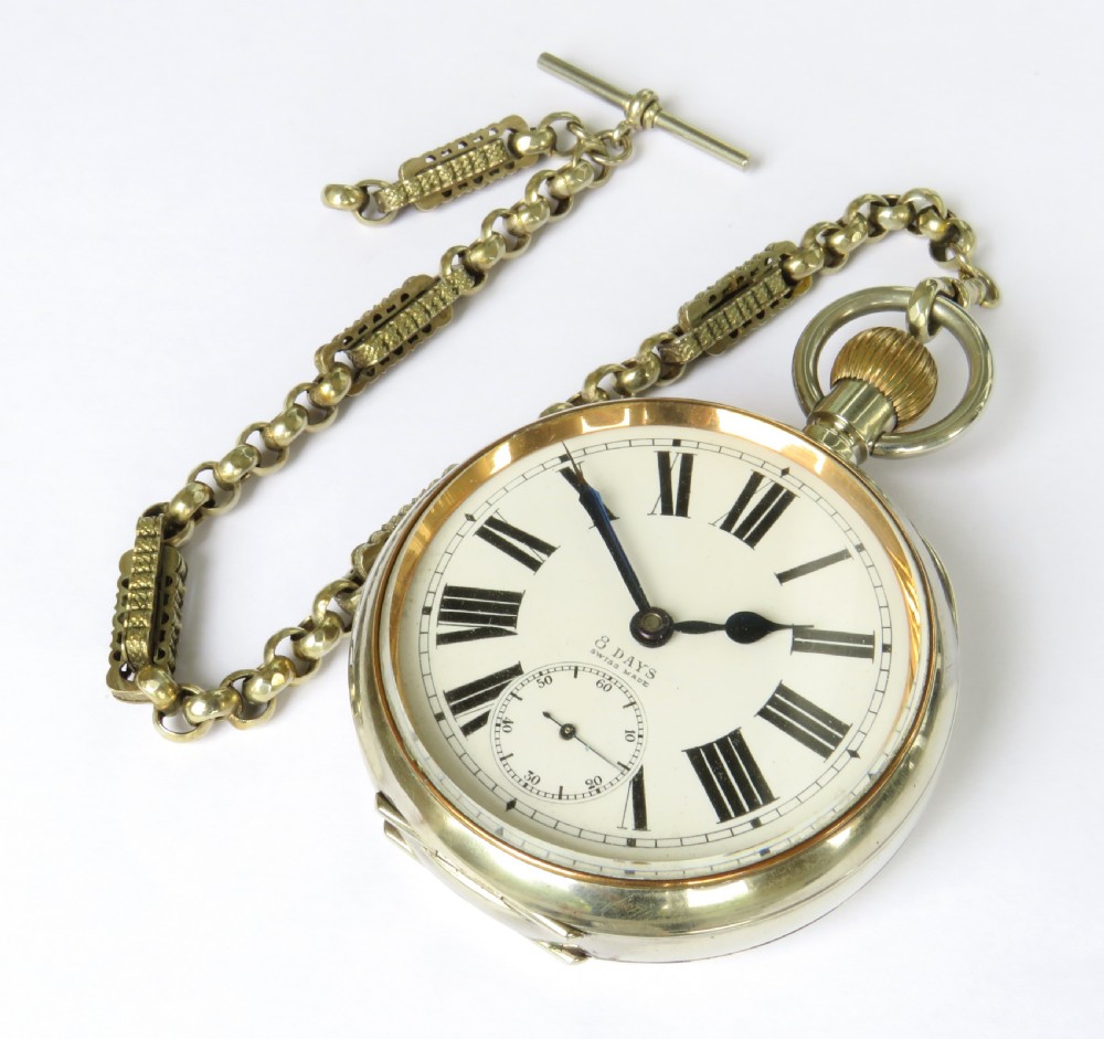 An antique nickel-cased goliath open-face pocket watch featuring a white enamel dial with Roman numerals, an eight-day movement marking, and an attached decorative brass chain. View II
