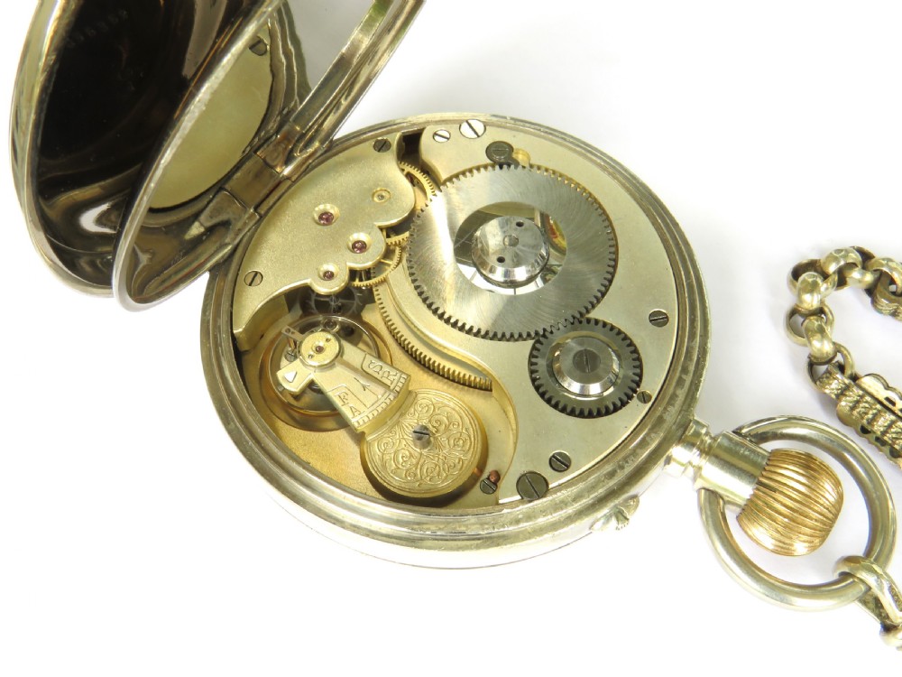 An antique nickel-cased goliath open-face pocket watch featuring a white enamel dial with Roman numerals, an eight-day movement marking, and an attached decorative brass chain. View IV