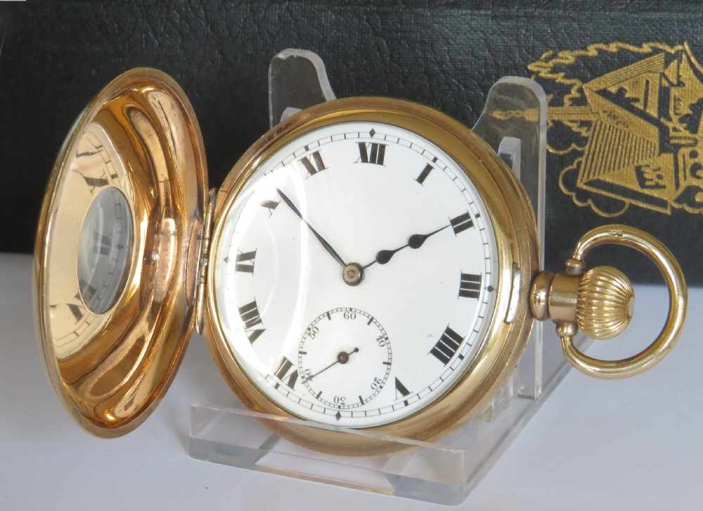 A 1920s gold half hunter pocket watch with enamel dial and black Roman numerals. View II