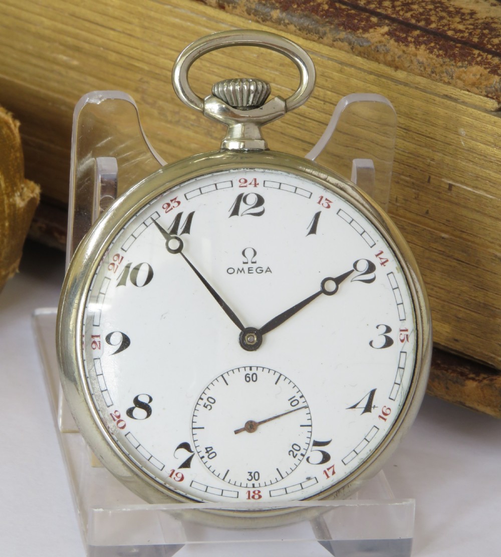 A 1943 open-face Omega pocket watch featuring a white enamel dial, black Arabic numerals, a sub-seconds dial, and a silver-toned metal case. View II