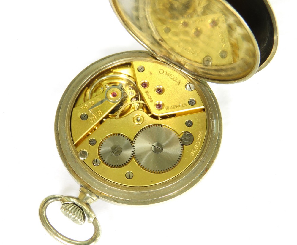 A 1943 open-face Omega pocket watch featuring a white enamel dial, black Arabic numerals, a sub-seconds dial, and a silver-toned metal case. View V