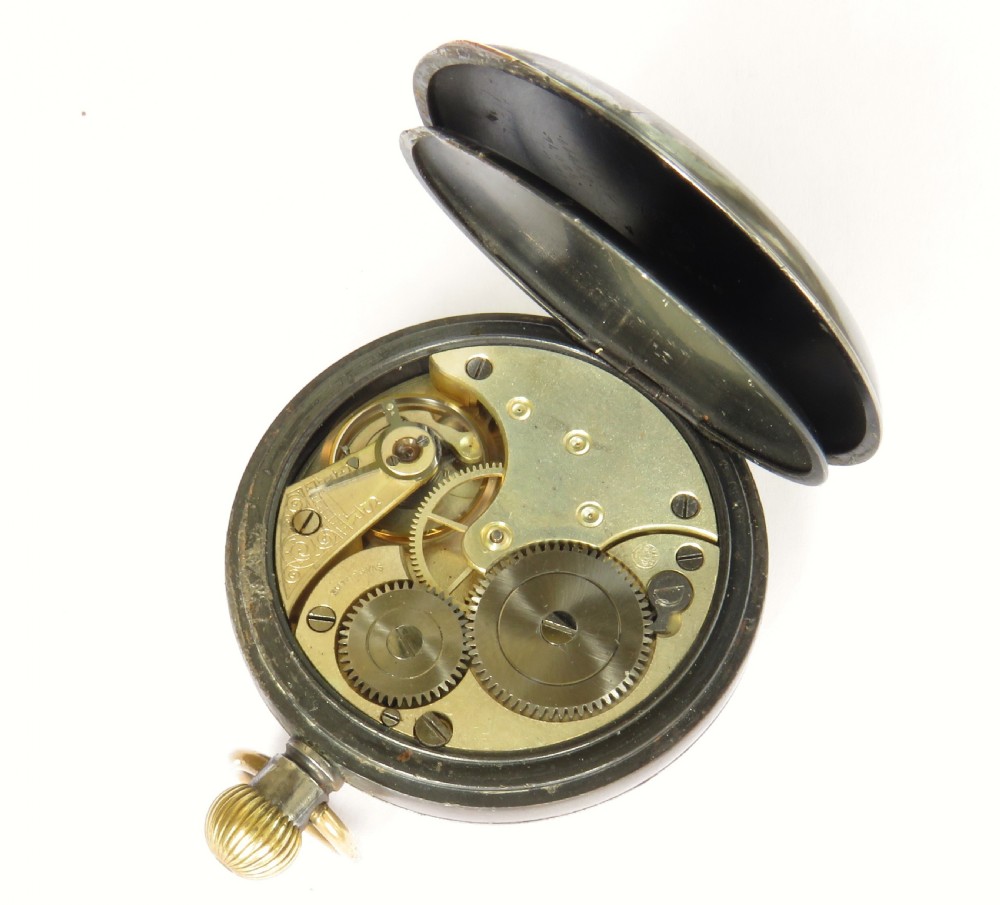 An antique open-face gunmetal pocket watch with a white enamel Roman numeral dial and brass Albert chain, set inside a red presentation case. View VI