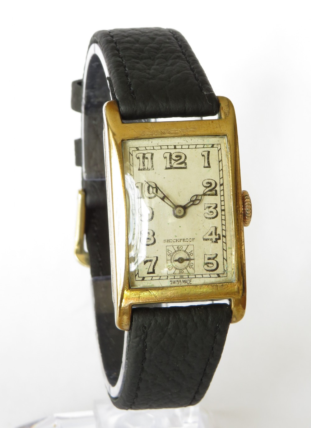 A 1930s rectangular Art Deco wristwatch by Rotary with a gold-plated case, cream dial with Arabic numerals, sub-seconds subdial, and a black leather strap. View II