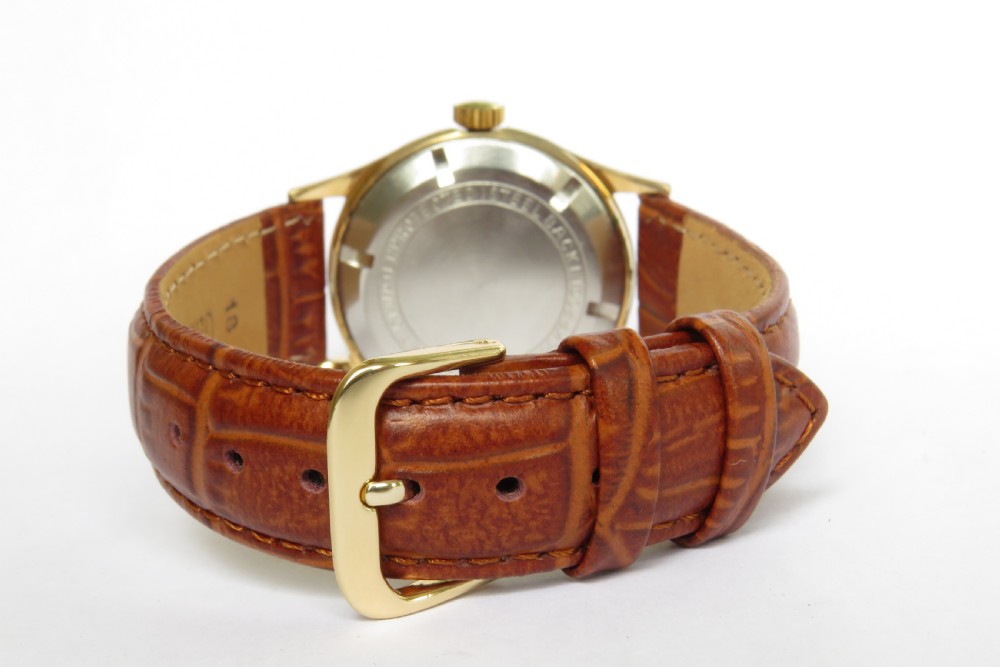 A 1960s gents Gloriosa mechanical wrist watch featuring a gold-toned case, cream dial with gold hour markers, and a textured brown leather strap. View III