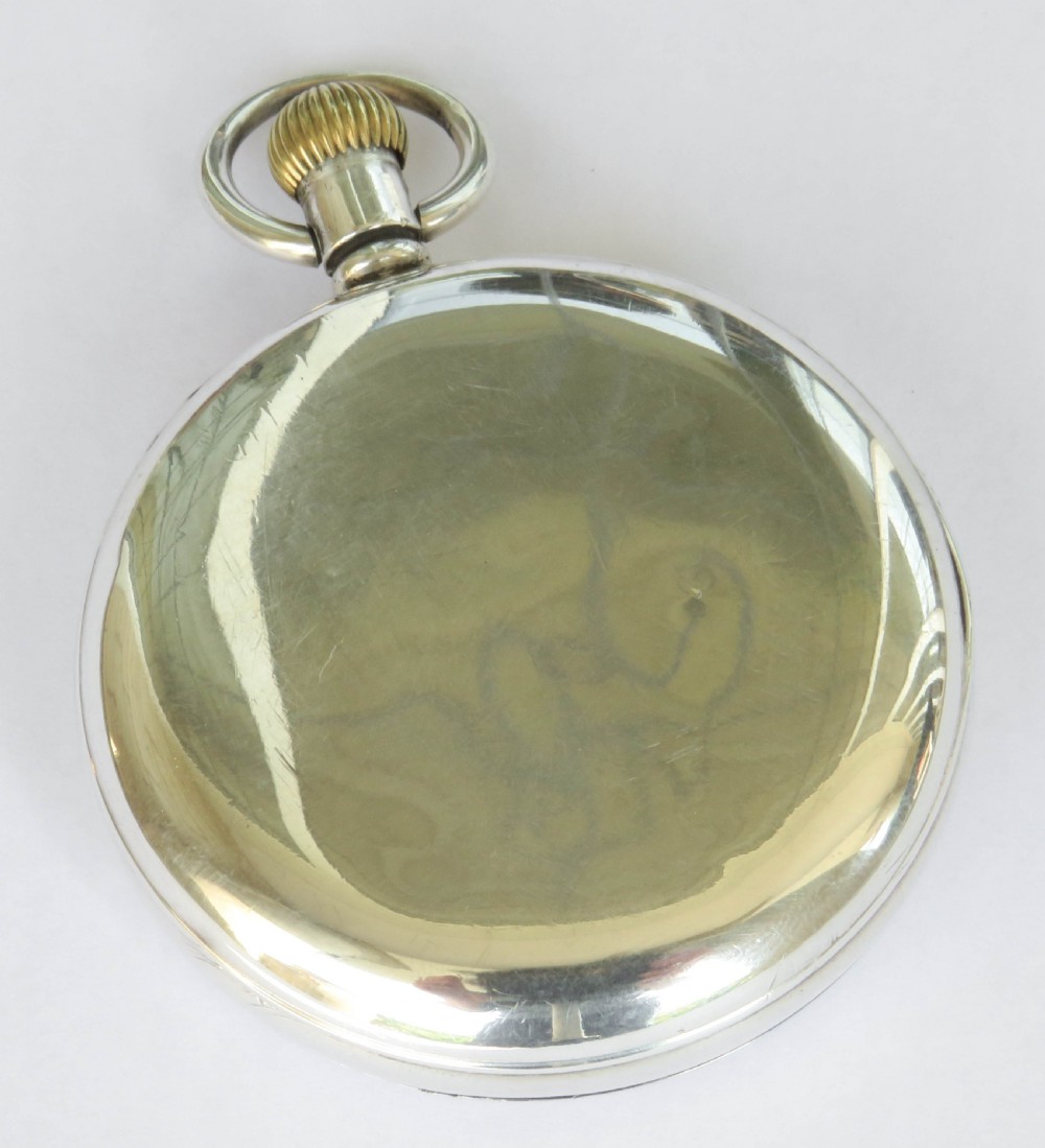 A 1930s silver open-face pocket watch with a white enamel dial, black Roman numerals, spade hands, and a subsidiary seconds dial. View V