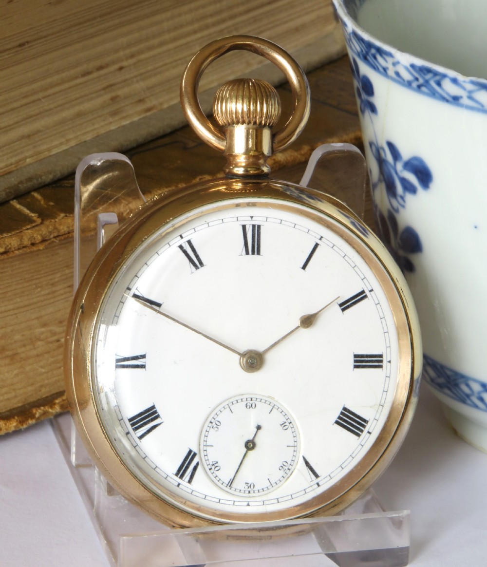 An open-face gold pocket watch featuring a white enamel dial, black Roman numerals, and a subsidiary seconds dial at six oclock. View II