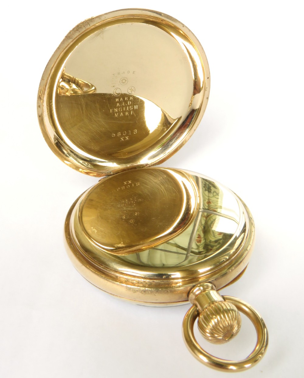 An open-face gold pocket watch featuring a white enamel dial, black Roman numerals, and a subsidiary seconds dial at six oclock. View III