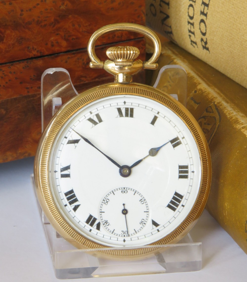 A 1920s open-face gold pocket watch featuring a white enamel dial with black Roman numerals and a subsidiary seconds dial. View II