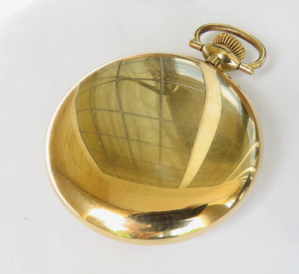 A 1920s open-face gold pocket watch featuring a white enamel dial with black Roman numerals and a subsidiary seconds dial. View IV