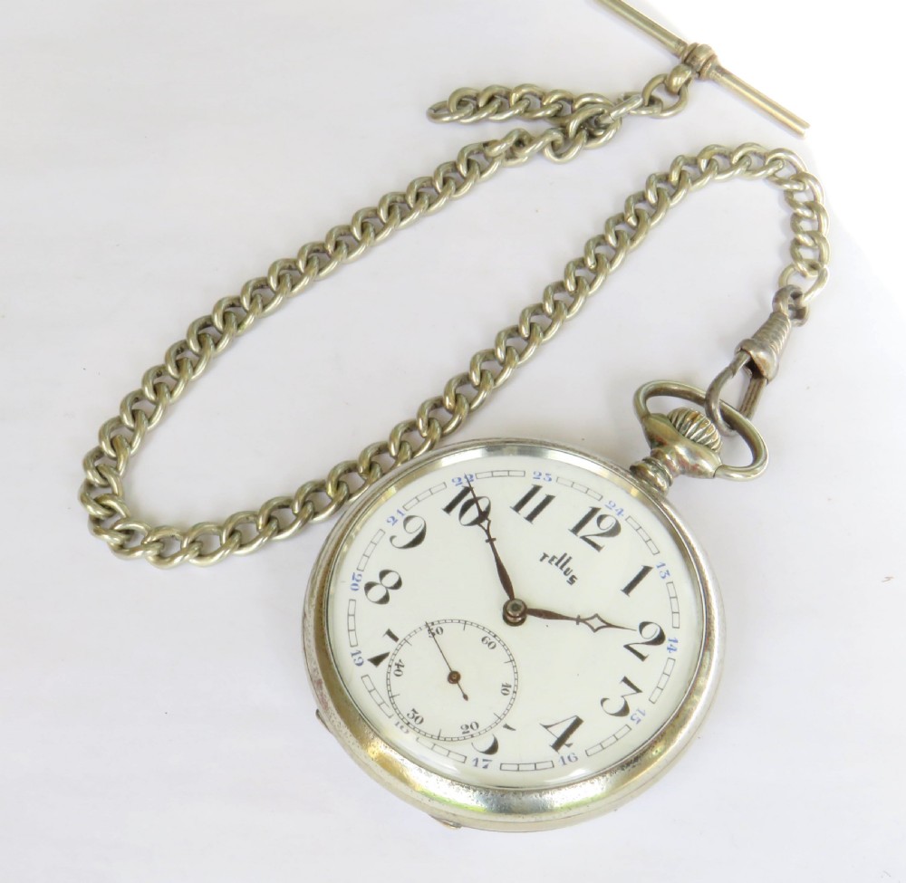 A 1930s Tellus open-face pocket watch featuring a white dial with black Arabic numerals and a silver-tone curb link chain with a T-bar. View II