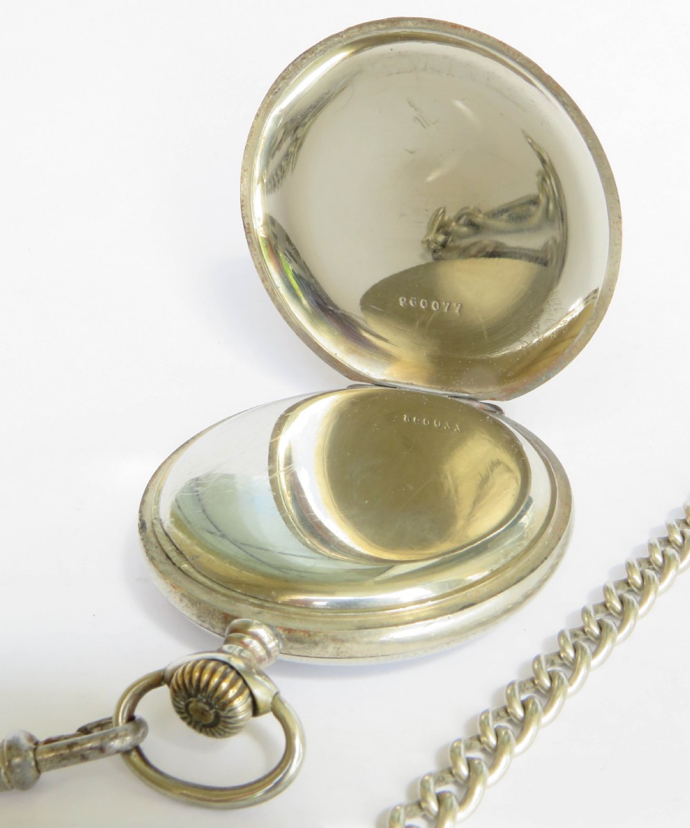 A 1930s Tellus open-face pocket watch featuring a white dial with black Arabic numerals and a silver-tone curb link chain with a T-bar. View III