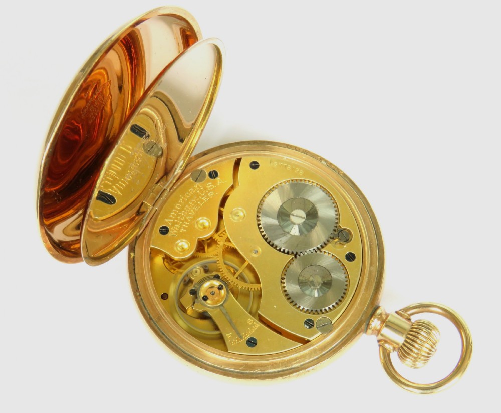 An open-face gold Waltham Traveler pocket watch featuring a white enamel dial with black Roman numerals and a subsidiary seconds dial. View III